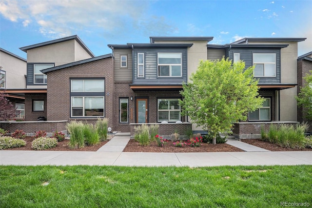 10066 Belvedere Cir, Lone Tree, CO 80124 - view of front of house with brick siding and a front yard