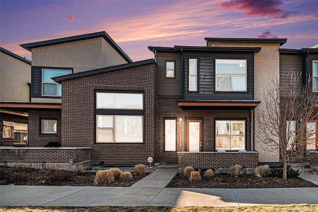 10066 Belvedere Cir, Lone Tree, CO 80124 - view of front of property featuring brick siding, a porch, and stucco siding