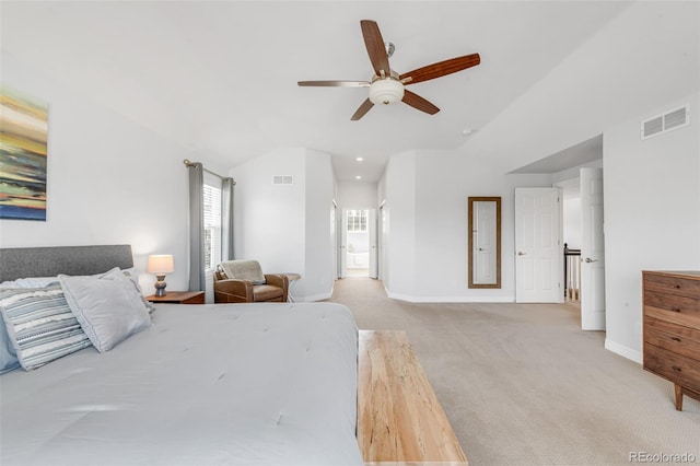 carpeted bedroom with baseboards, visible vents, and vaulted ceiling