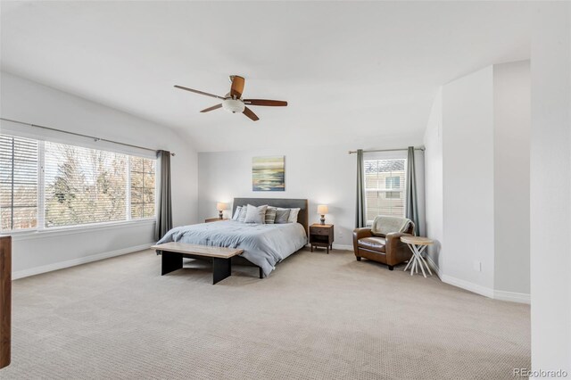 bedroom with carpet, baseboards, vaulted ceiling, and ceiling fan