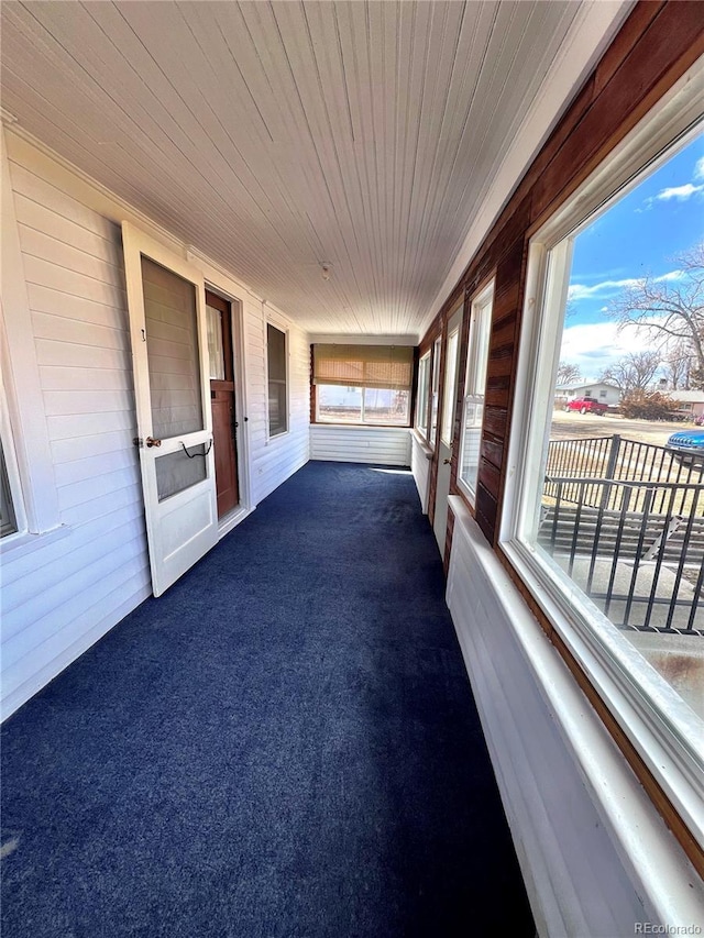 unfurnished sunroom with wood ceiling