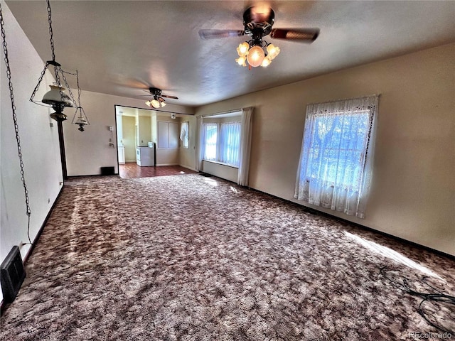 unfurnished living room with carpet, visible vents, and ceiling fan