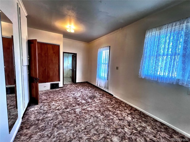 interior space with crown molding and carpet flooring