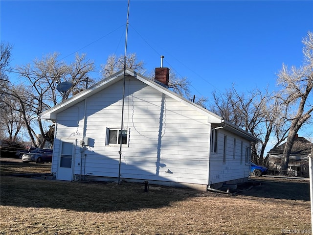 view of property exterior featuring a chimney