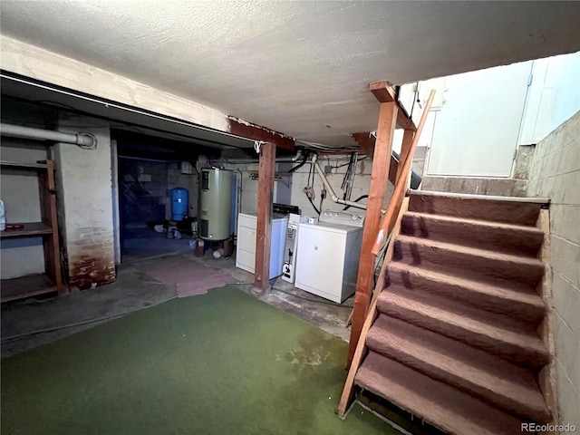 unfinished below grade area featuring a textured ceiling, stairs, water heater, and washer and dryer