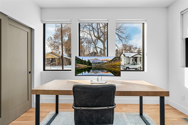 office with baseboards and wood finished floors