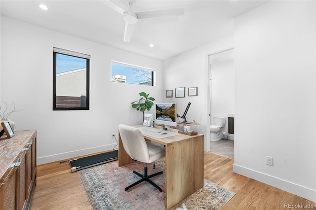 office space featuring recessed lighting, baseboards, and light wood-style flooring