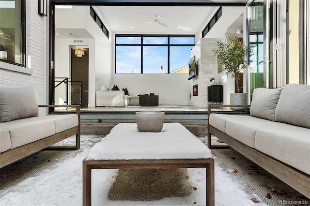 living area featuring visible vents and ceiling fan