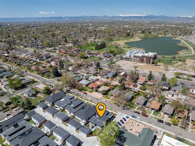 drone / aerial view featuring a residential view and a water and mountain view