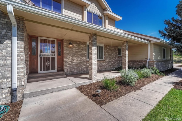 view of exterior entry with covered porch