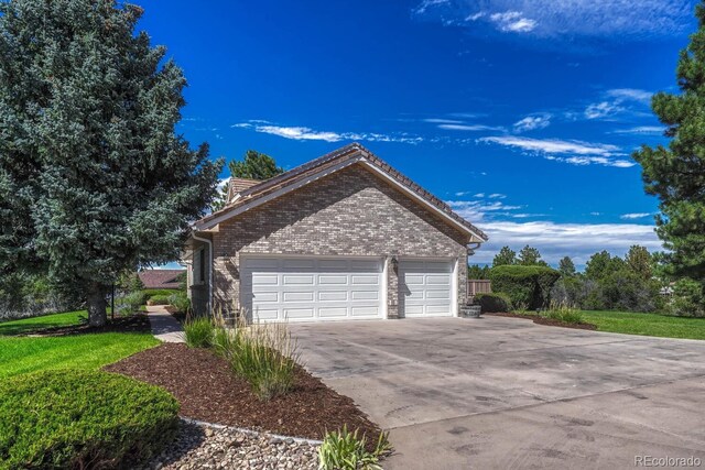 view of property exterior with a yard and a garage