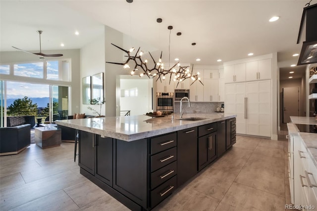 3585 Meadow Run Cir, Colorado Springs, CO 80908 - kitchen featuring a sink, stainless steel appliances, white cabinets, tasteful backsplash, and recessed lighting