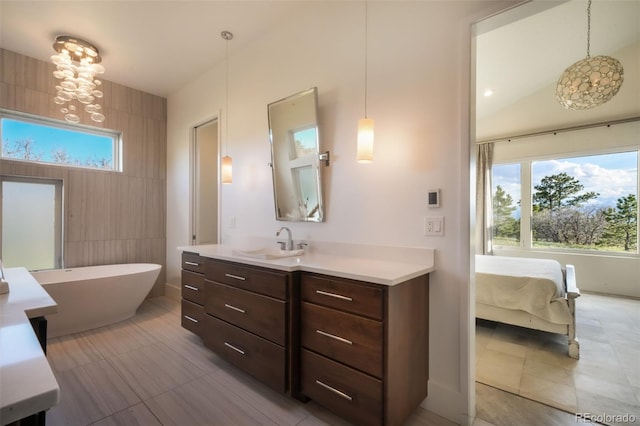 3585 Meadow Run Cir, Colorado Springs, CO 80908 - full bath with a soaking tub, vanity, a chandelier, and tile patterned flooring