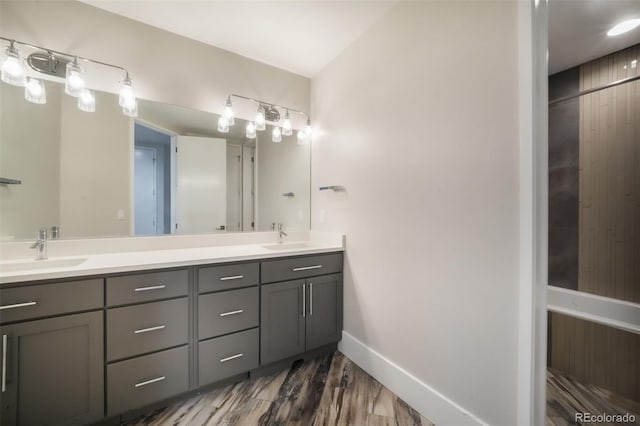 3585 Meadow Run Cir, Colorado Springs, CO 80908 - bathroom with double vanity, wood finished floors, and baseboards