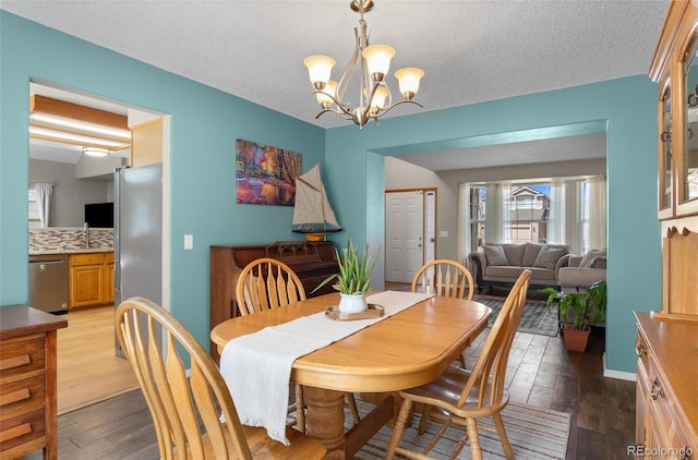 17018 Carr Ave, Parker, CO 80134 - dining room with a chandelier, wood finished floors, and a textured ceiling