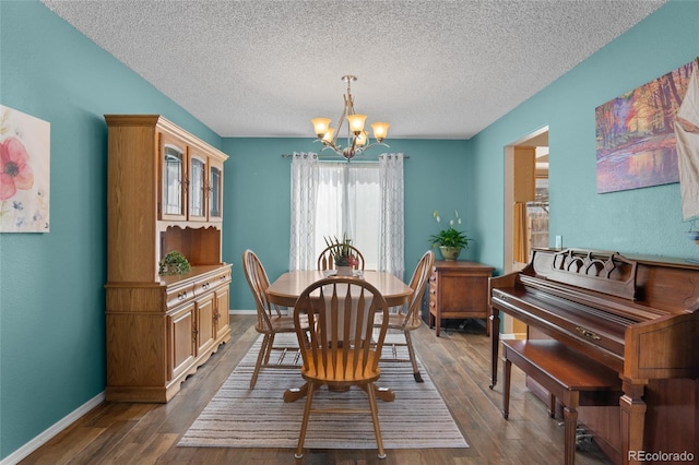 17018 Carr Ave, Parker, CO 80134 - dining room with a chandelier, dark wood-style flooring, a textured ceiling, and baseboards