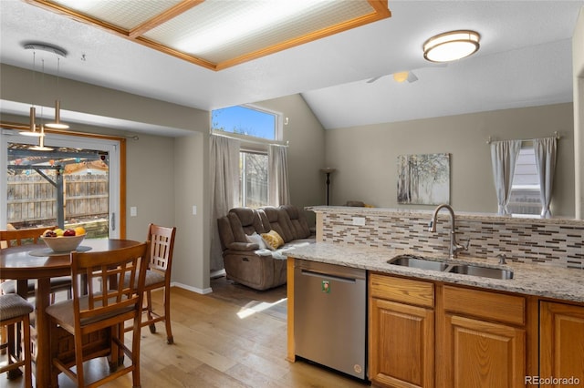 17018 Carr Ave, Parker, CO 80134 - kitchen featuring dishwasher, a sink, open floor plan, light wood-style flooring, and light stone countertops