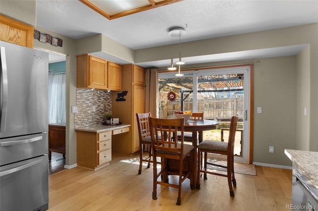 17018 Carr Ave, Parker, CO 80134 - dining room with light wood-type flooring and baseboards