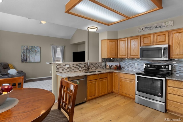17018 Carr Ave, Parker, CO 80134 - kitchen with stainless steel appliances, a sink, open floor plan, backsplash, and vaulted ceiling