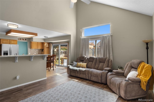 17018 Carr Ave, Parker, CO 80134 - living area with wood finished floors, high vaulted ceiling, a ceiling fan, and baseboards