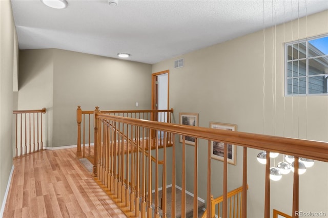 17018 Carr Ave, Parker, CO 80134 - hallway with an upstairs landing, wood finished floors, and baseboards