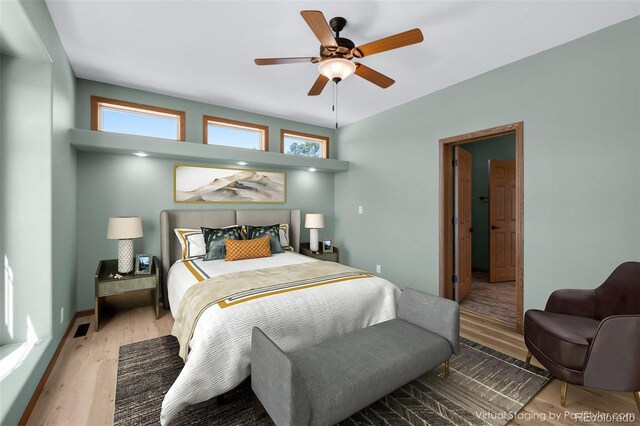 12730 Porcupine Ln, Colorado Springs, CO 80908 - bedroom with wood finished floors, multiple windows, and ceiling fan