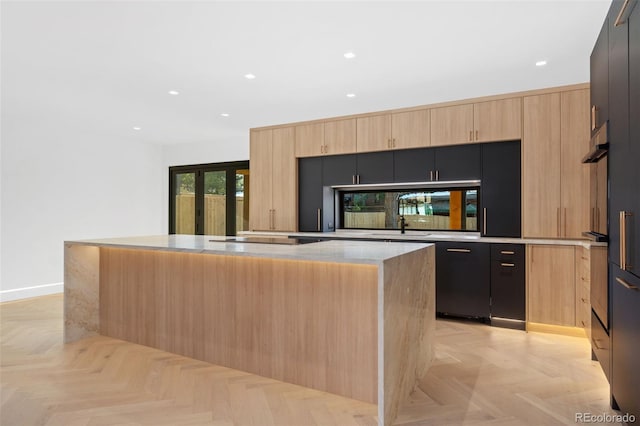 kitchen featuring a kitchen island, oven, light brown cabinetry, french doors, and modern cabinets