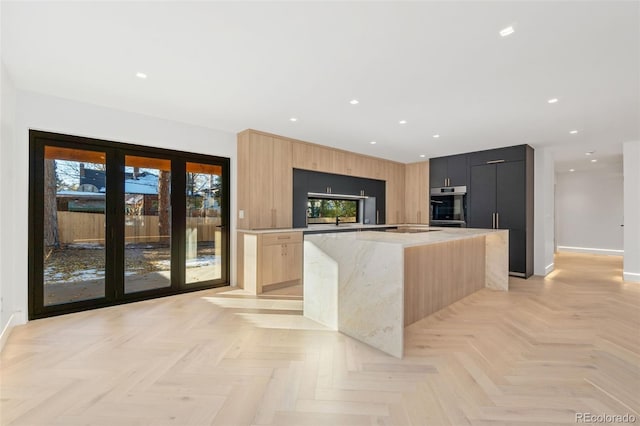 kitchen with light brown cabinets, a center island, oven, recessed lighting, and modern cabinets