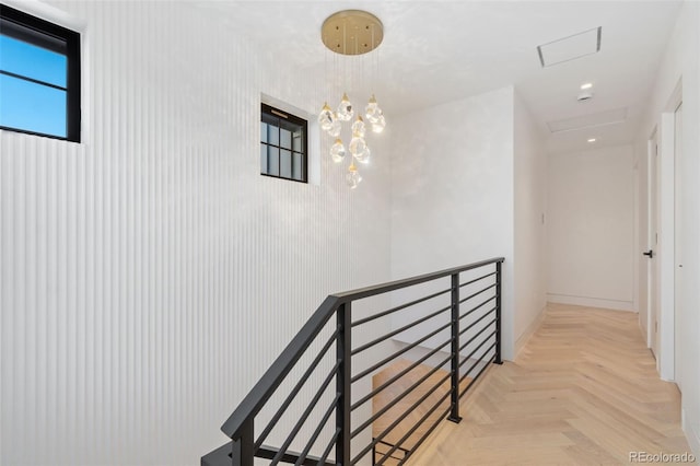 hall featuring recessed lighting, an upstairs landing, and an inviting chandelier