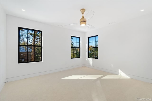 carpeted spare room with baseboards and ceiling fan