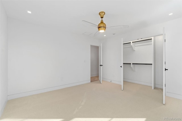 unfurnished bedroom with baseboards, light colored carpet, a closet, and ceiling fan