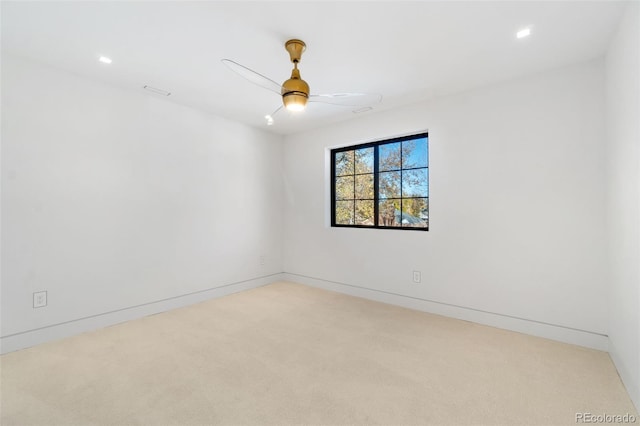 empty room with a ceiling fan, carpet, and baseboards