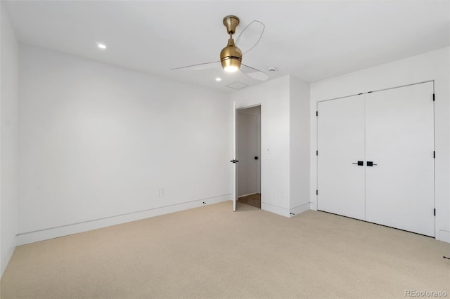 unfurnished bedroom with baseboards, recessed lighting, ceiling fan, a closet, and light carpet