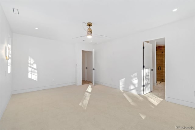 unfurnished bedroom with visible vents, light colored carpet, baseboards, and a ceiling fan