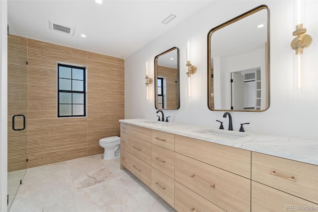 full bathroom featuring double vanity, visible vents, toilet, and a sink