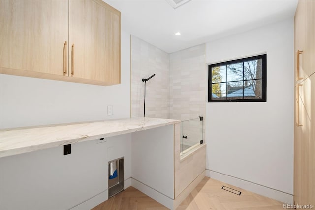 washroom with recessed lighting and cabinet space