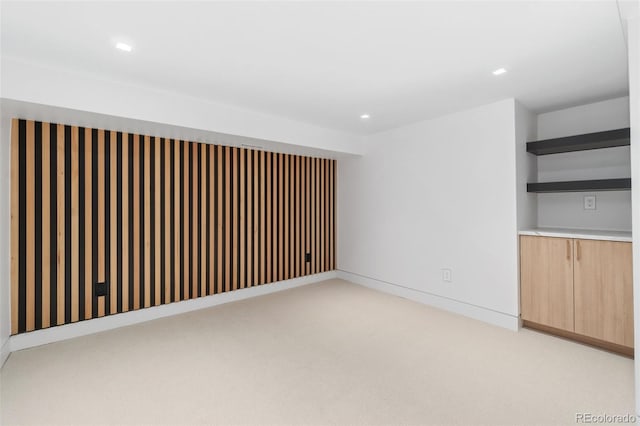 spare room with recessed lighting, light colored carpet, and baseboards