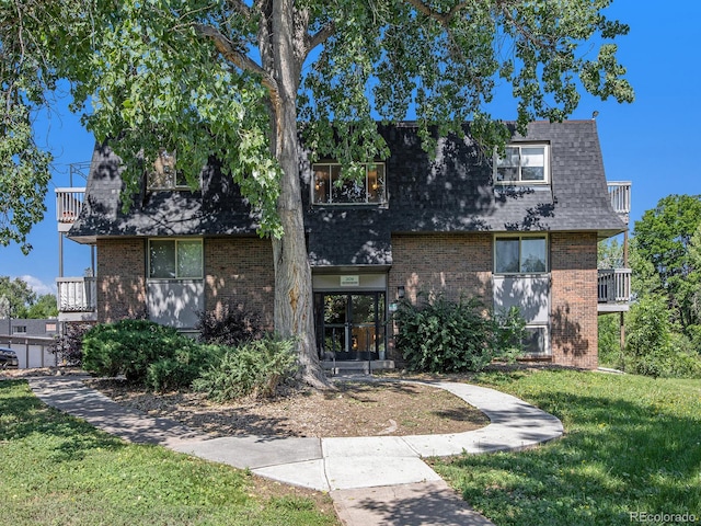 309 E Highline Cir Unit 104, Centennial, CO 80122 - view of front of property with mansard roof, roof with shingles, brick siding, and a balcony