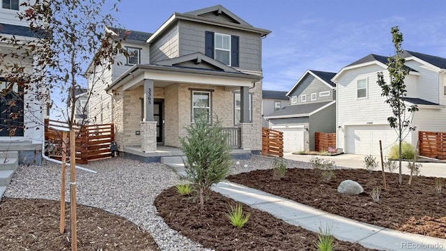 3365 N Coolidge Way, Aurora, CO 80019 - view of front of home with a porch, an attached garage, and driveway