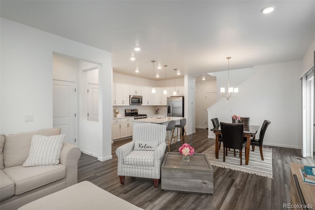 3365 N Coolidge Way, Aurora, CO 80019 - living room featuring a chandelier, dark wood-style flooring, baseboards, and recessed lighting