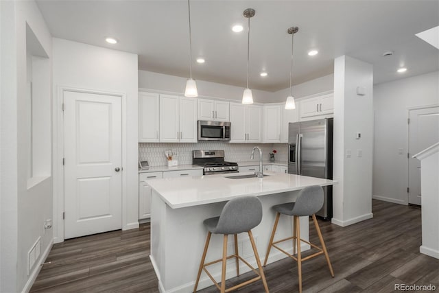 3365 N Coolidge Way, Aurora, CO 80019 - kitchen featuring stainless steel appliances, a sink, dark wood finished floors, white cabinetry, and recessed lighting