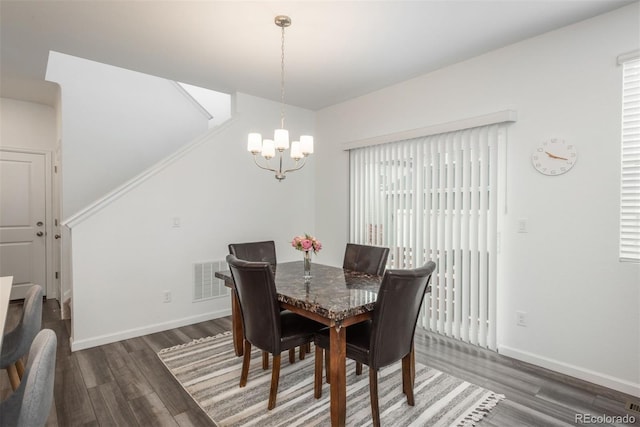 3365 N Coolidge Way, Aurora, CO 80019 - dining space featuring a chandelier, wood finished floors, and baseboards