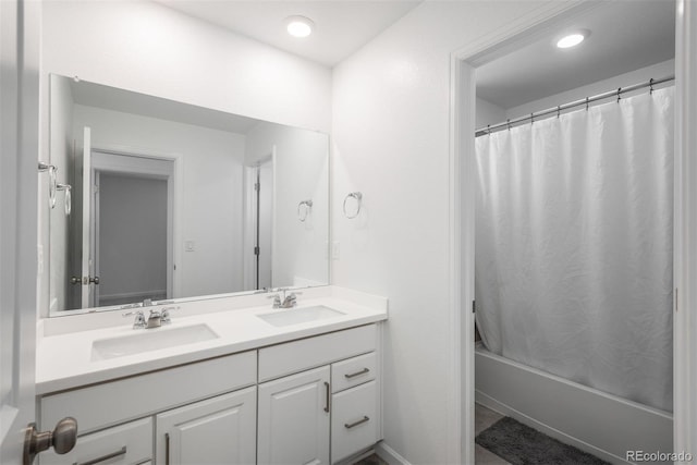 3365 N Coolidge Way, Aurora, CO 80019 - full bath featuring double vanity, shower / tub combo with curtain, and recessed lighting