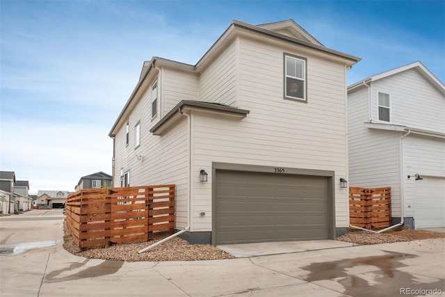3365 N Coolidge Way, Aurora, CO 80019 - view of side of property featuring a garage and concrete driveway