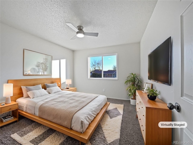 carpeted bedroom with a ceiling fan and a textured ceiling