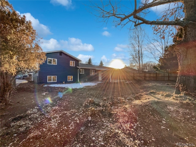 back of house with fence