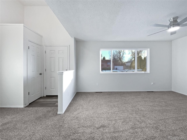 spare room with ceiling fan, a textured ceiling, carpet, and baseboards