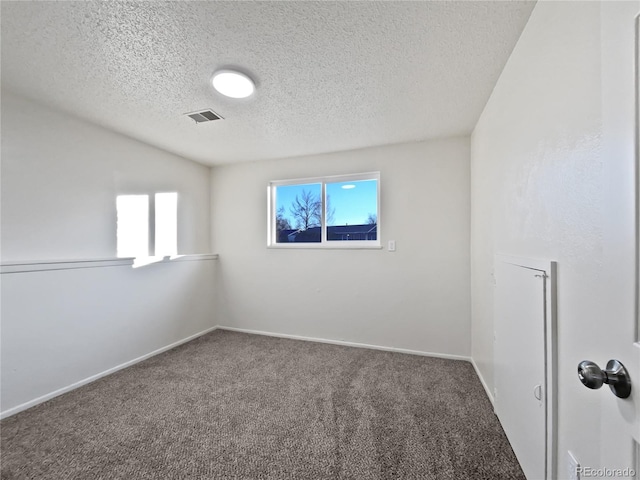 empty room featuring baseboards, visible vents, a textured ceiling, and carpet flooring