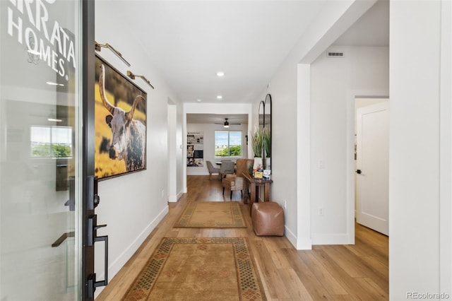 hallway with light hardwood / wood-style floors