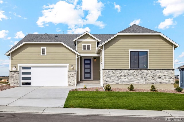 view of front of house with a front lawn, concrete driveway, roof with shingles, stone siding, and an attached garage